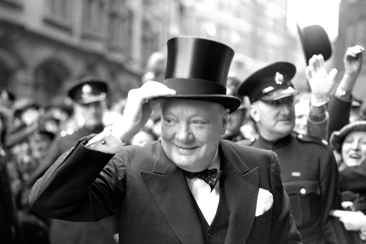Winston Churchill arrives at Church House to receive the Honorary Freedom of the City of Westminster in 1946. He wears a three piece suit, polka dot silk bow tie and top hat.-James Wilson